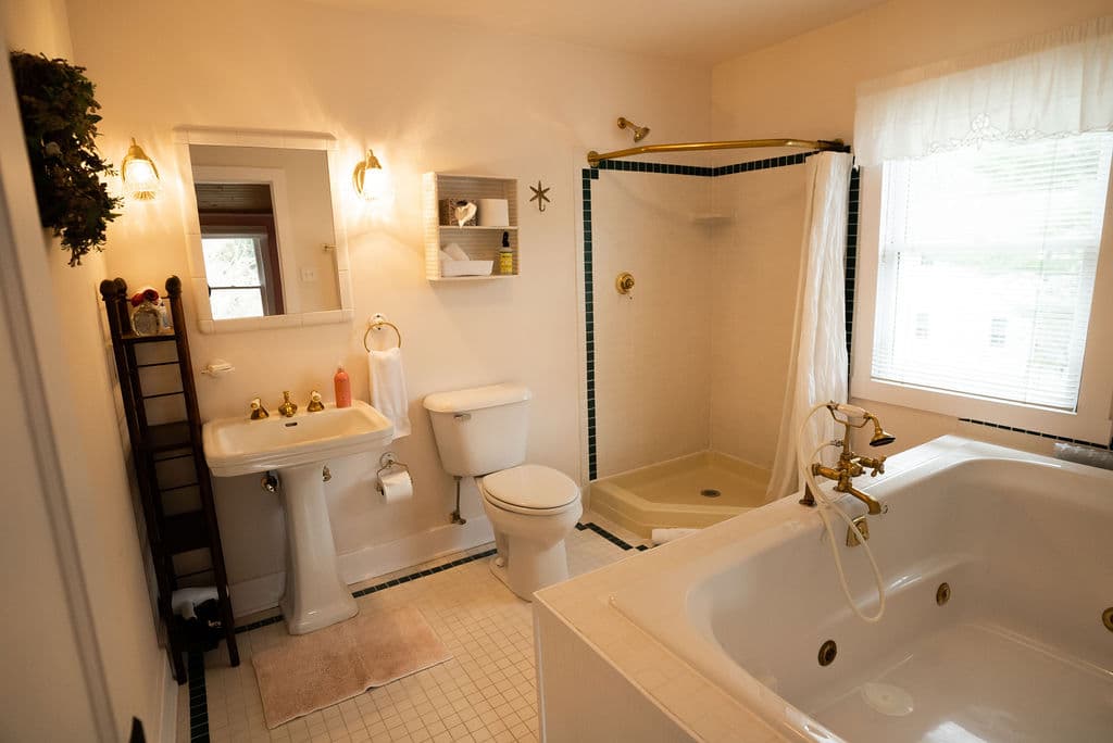 Rose room bathroom with jacuzzi tub, separate shower, toilet and sink