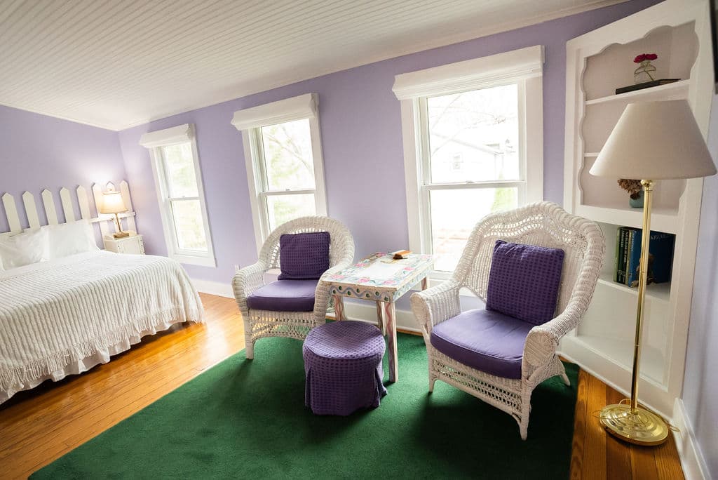 View of sitting area to bed in background