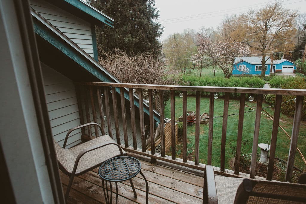 Two chairs and small table on patio overlooking butterfly garden
