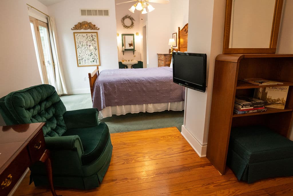 Sitting area with TV that leads into bedroom