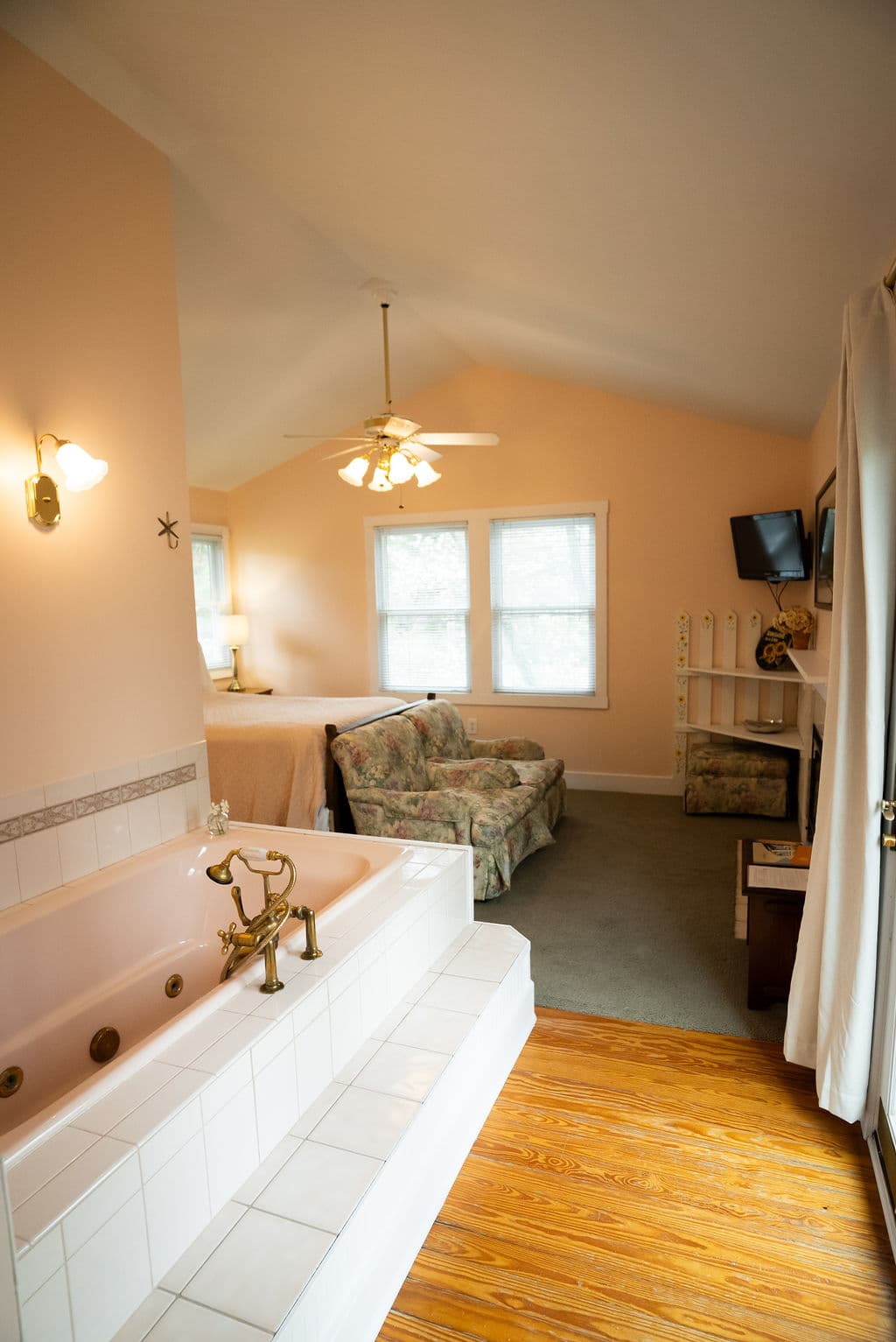 View into bedroom past the jacuzzi tub and patio doors