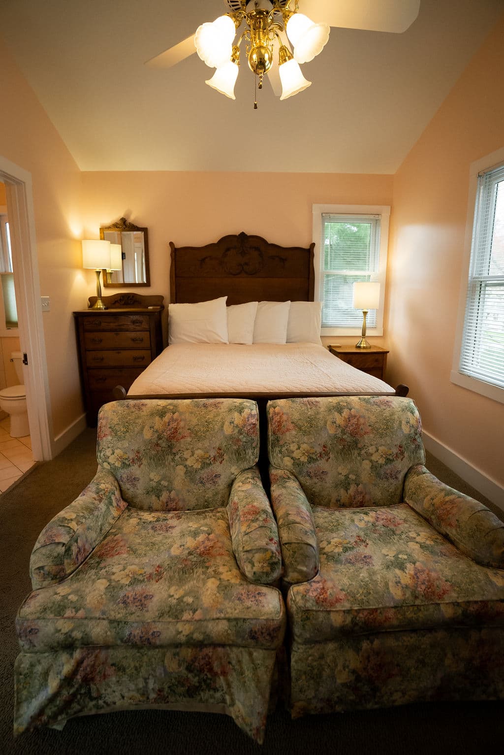 View of chairs against queen size bed