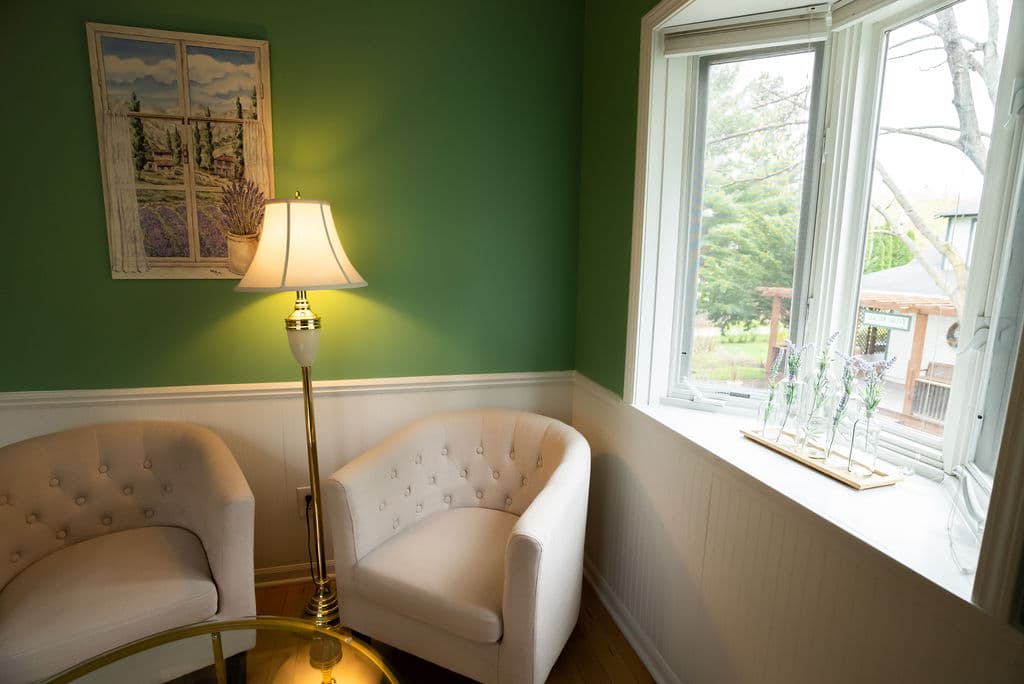Sitting area by windows overlooking the shade garden