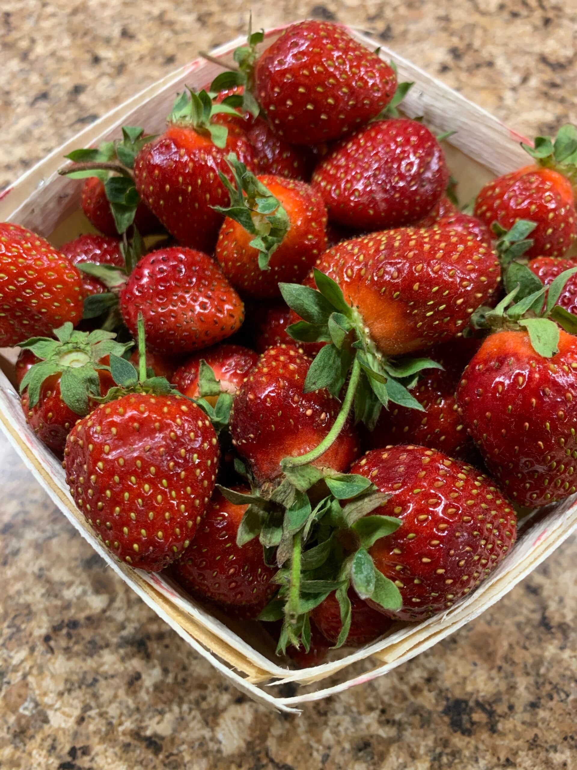 A basket filled with fresh, ripe strawberries. A basket filled with fresh, ripe strawberries.