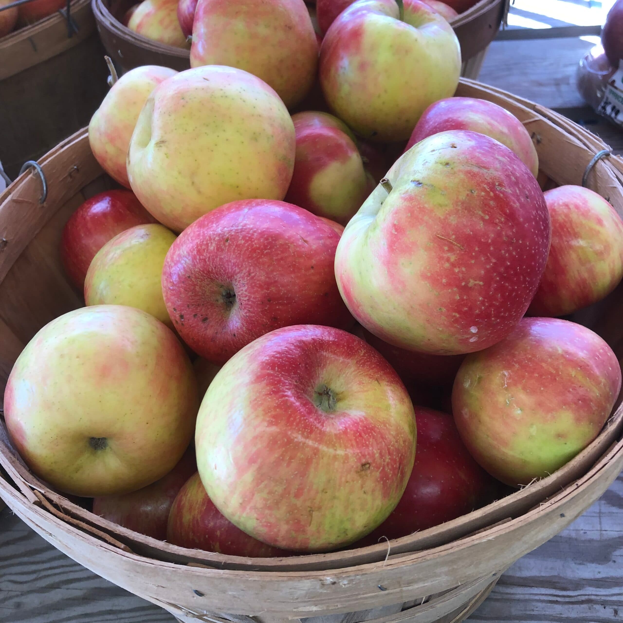 A basket full of red and yellow apples.